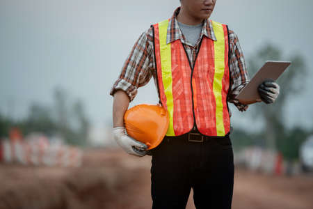 Construction engineer supervising work at construction siteの写真素材