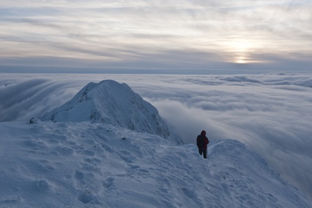 a climber on the mountain in winter, Piatra Craiului Mountains, Romania