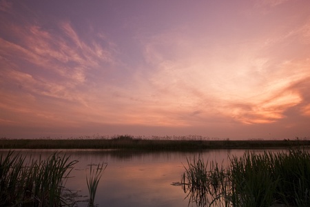 an array of colorful clouds over lakeの写真素材