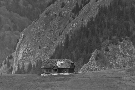 an old abandoned house near a mountainの写真素材