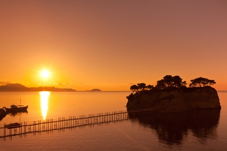 sunrise at sea and on a small islandの写真素材