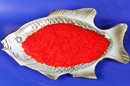 red caviar on a fish shaped platterの写真素材