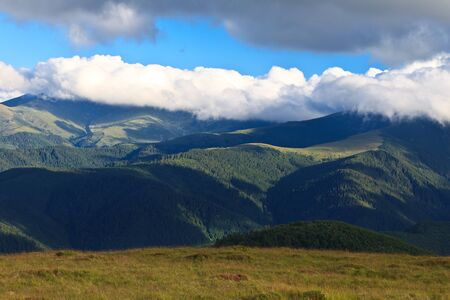 mountains and clouds in a blue sky