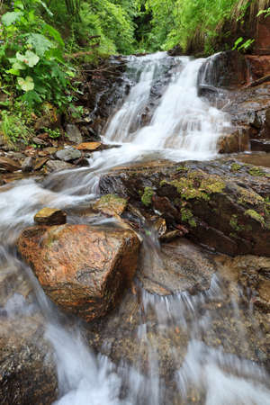 a beautiful waterfall on a mountain slope