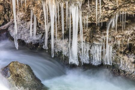 a small waterfall on a mountain creekの写真素材