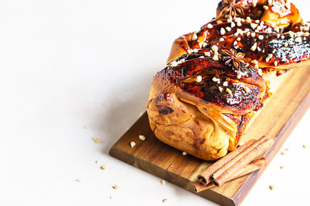 Babka or brioche bread with apricot jam and nuts. Homemade pastry for breakfast. Concrete...
