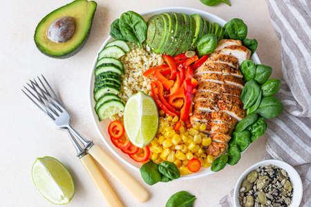 Bowl with bulgur, grilled chicken, bell pepper, cucumber, corn, avocado and spinach. Buddha bowl....