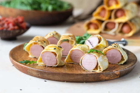 Homemade sausages in dough with sesame served with tomato sauceの写真素材