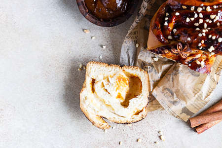Babka or brioche bread with apricot jam and nuts. Homemade pastry for breakfast. Concrete...