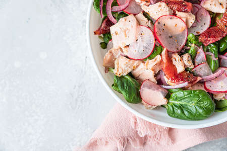 Salad with spinach, grilled salmon, radish and Sicilian red oranges.の写真素材