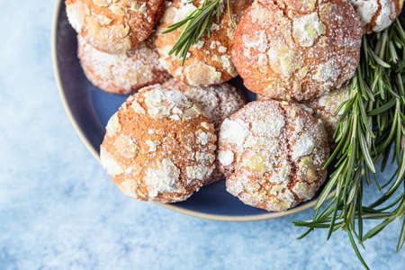 Homemade orange shortbread crinkle cookies with powdered sugar, rosemary and Sicilian blood oranges...