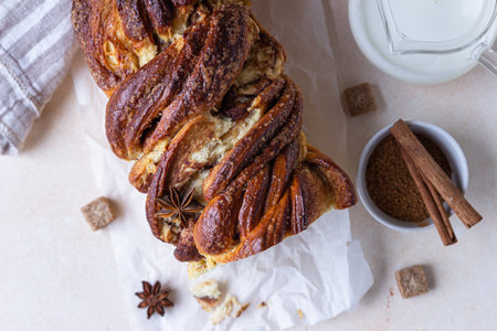 Babka or brioche bread with cinnamon and brown sugar. Homemade pastry for breakfast. Selective focus. Top view.の写真素材
