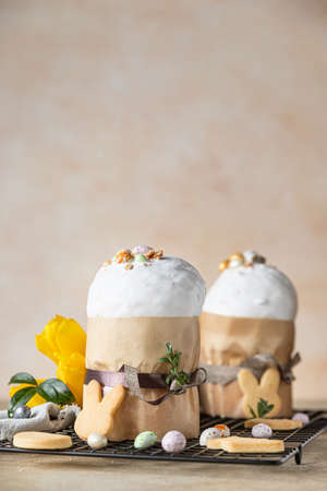 Easter composition with traditional Orthodox sweet bread. Kulich decorated with meringue icing,...
