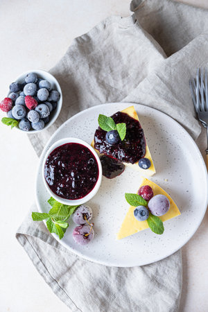 Vanilla no crust cheesecake or cottage cheese casserole decorated with mint and berries. Ricotta casserole. Healthy breakfast or dessert. Top view.の写真素材