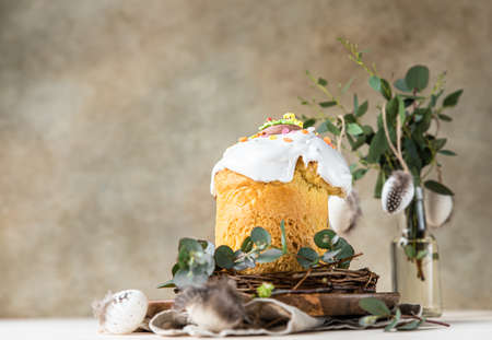 Easter composition with traditional Orthodox sweet bread. Kulich decorated with meringue icing,...