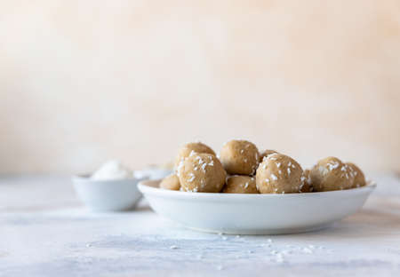 Chickpea and peanut butter candies with coconut chips. energy balls. Healthy raw dessert without...