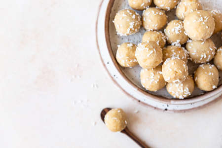 Chickpea and peanut butter candies with coconut chips. energy balls. Healthy raw dessert without...
