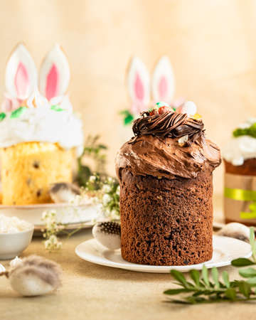 Easter composition with assortment of traditional Orthodox sweet bread. Kulich decorated with...
