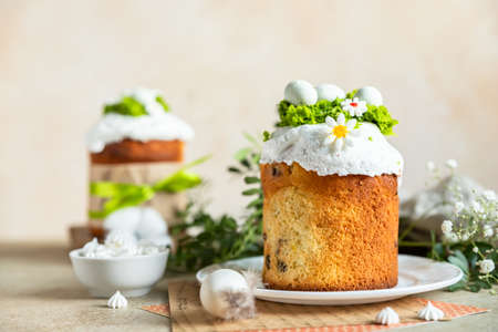 Happy Easter. Traditional Russian or Ukrainian Easter cake Kulich with meringue icing, candy shaped...