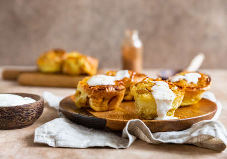 Portion Dutch baby pancakes with apples served with cream, honey and cinnamon on plate. Delicious...