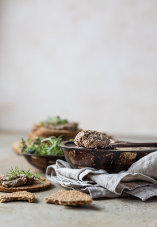 Homemade meat or chicken liver pate with multigrain crackers and microgreen, concrete background.の写真素材