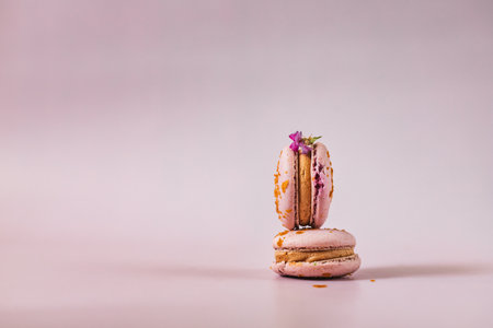French or Italian macarons with coffee and vanilla filling, pink background. Dessert for tea or coffee break. food background. pastel color.の写真素材