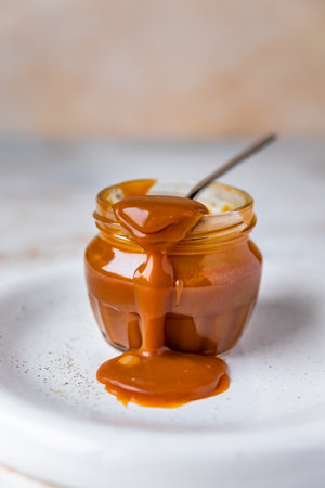 Jar of salted caramel sauceの写真素材
