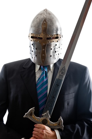 A Young Businessman isolated on a white background holding a steel sword and wearing an helmの写真素材