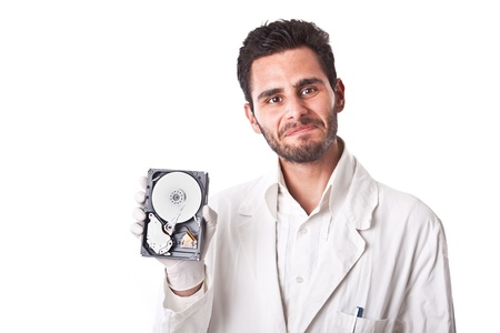 a technician wearing lab coat holding an hard disk drive