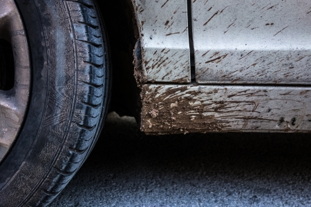 detail of a car wheel and some mud tainting the carの写真素材