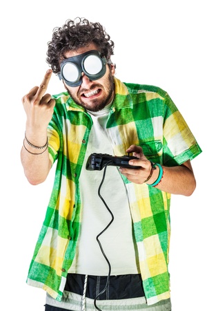 a guy wearing casual clothes and on old pair of goggles over a white bachground and using a gamepad controllerの写真素材