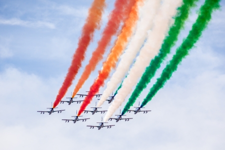 The italian acrobatic jet squad named "frecce tricolori" doing tricks in the skyの写真素材