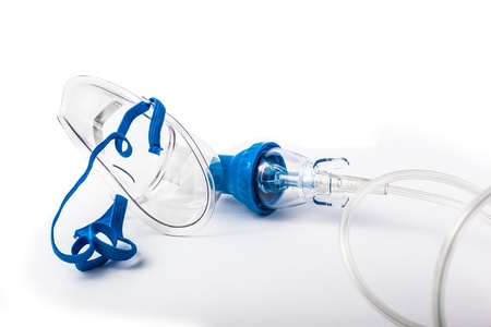 a medical oxygen mask isolated over a white backgroundの写真素材