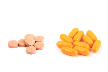 two heaps of pills isolated over a white background