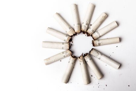 some cigarette's butt arranged in a circle and isolated on a white background