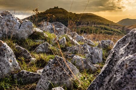 a beautiful mountain landscape with a vibrant, dramatic sky and some cloudsの写真素材