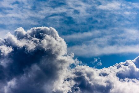 sot of a dramatic blue sky with a big cumulus growing in height
