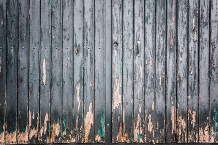 an old wooden and grungy locked door typical of the south of italyの写真素材