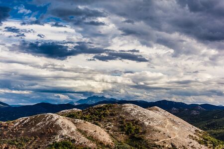a beautiful mountain landscape with a vibrant, dramatic sky and some cloudsの写真素材