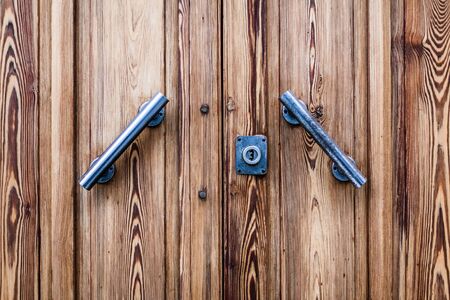 an old wooden and grungy locked door typical of the south of italyの写真素材