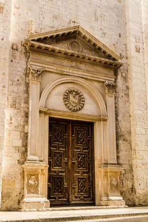 a beautiful wooden portal of a church in south italyの写真素材