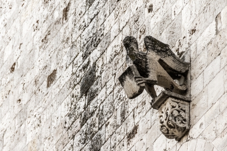 an ancient sculpture on the facade of a church in italyの写真素材