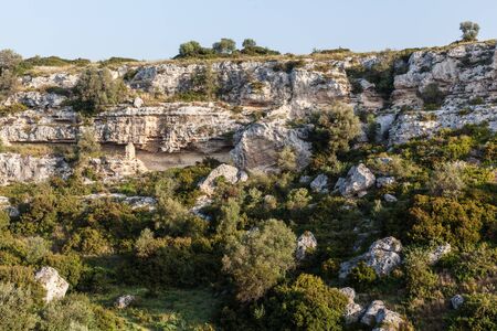 a harsh cliff located in the Riggio ravine, near Grottaglie, a small town in south Italyの写真素材