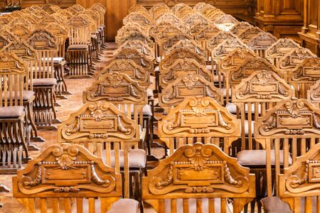 a lot of luxurious and expensive royal chairs arranged in rows inside an elegant hallの写真素材