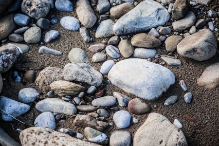 some roundish pebbles on the side of a small torrentの写真素材