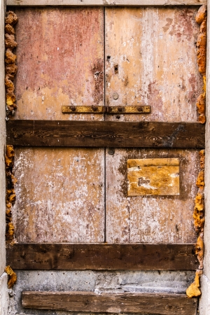 a rusty, abandoned and boarded up old doorの写真素材