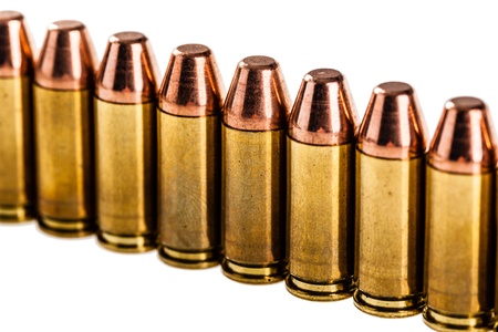 a row of unused 9mm bullets isolated on white