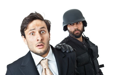 a corrupted businessman being arrested by a swat agentの写真素材