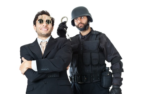 a corrupted businessman being arrested by a swat agentの写真素材