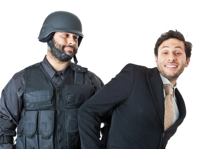 a corrupted businessman being arrested by a swat agentの写真素材